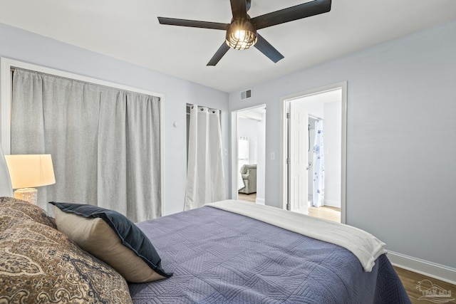 bedroom featuring visible vents, ceiling fan, baseboards, and wood finished floors