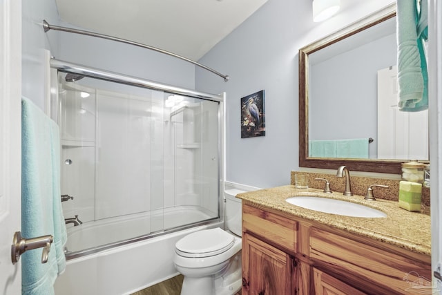 full bath featuring shower / bath combination with glass door, vanity, and toilet