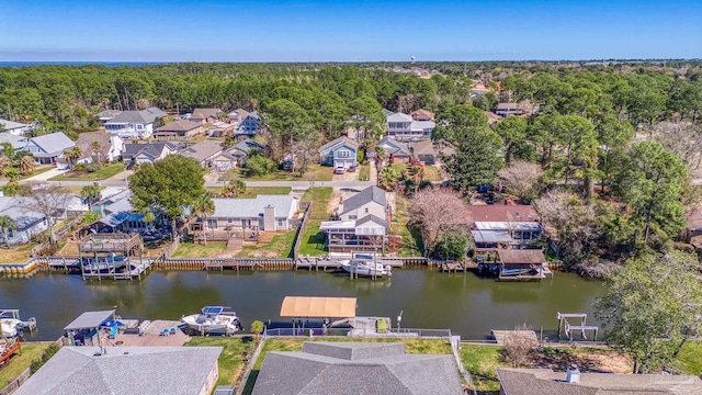 birds eye view of property featuring a water view, a forest view, and a residential view