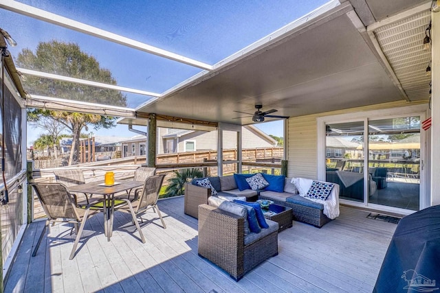 wooden terrace featuring ceiling fan, outdoor dining space, and outdoor lounge area