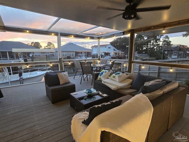 wooden terrace featuring ceiling fan, glass enclosure, and outdoor lounge area