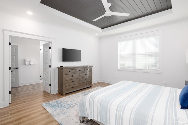 bedroom with light wood-type flooring, a raised ceiling, ceiling fan, and wooden ceiling