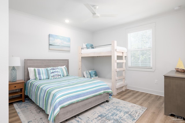 bedroom featuring ceiling fan, crown molding, and light hardwood / wood-style flooring