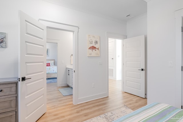 bedroom featuring light wood-type flooring and ornamental molding