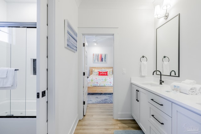 bathroom featuring vanity, a shower with shower door, and hardwood / wood-style flooring