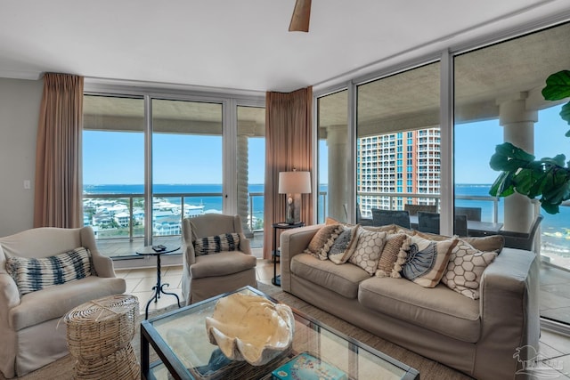 tiled living room featuring a water view and floor to ceiling windows