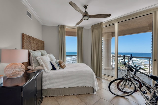 bedroom with a water view, multiple windows, and ceiling fan