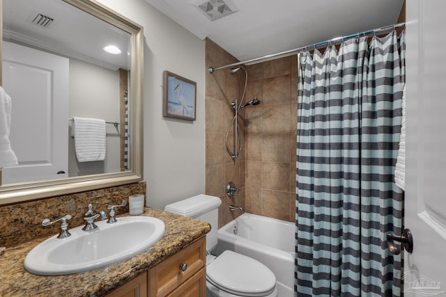 full bathroom featuring vanity, shower / tub combo with curtain, and toilet