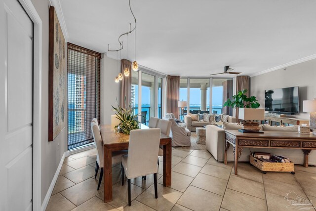 tiled dining room with crown molding and floor to ceiling windows