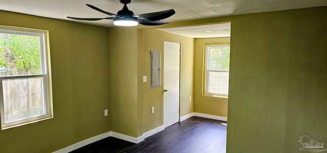 607 Hannah St, Pensacola, FL 32534 - unfurnished room with dark wood-type flooring, baseboards, a ceiling fan, and a healthy amount of sunlight
