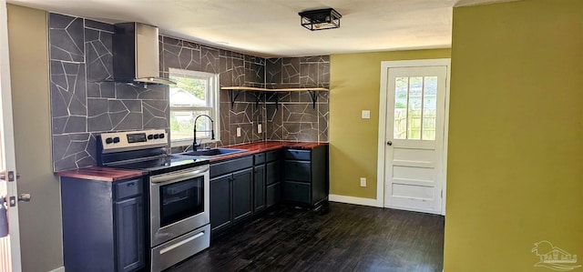 607 Hannah St, Pensacola, FL 32534 - kitchen with butcher block countertops, wall chimney range hood, dark wood-style floors, electric range, and a sink