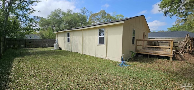 607 Hannah St, Pensacola, FL 32534 - view of side of home featuring a fenced backyard, a wooden deck, and a lawn