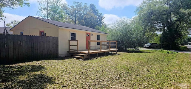 607 Hannah St, Pensacola, FL 32534 - exterior space with fence, a deck, and a lawn