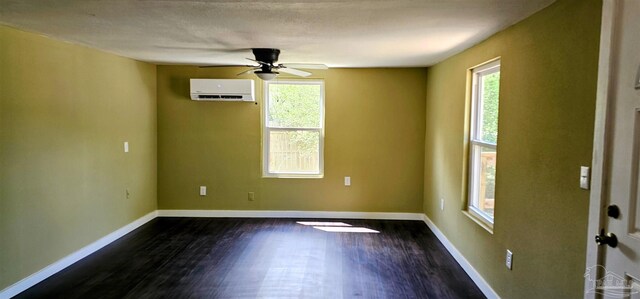 607 Hannah St, Pensacola, FL 32534 - empty room featuring dark wood finished floors, baseboards, and a wall unit AC