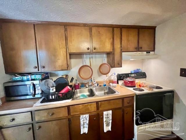 kitchen featuring sink and white electric range oven