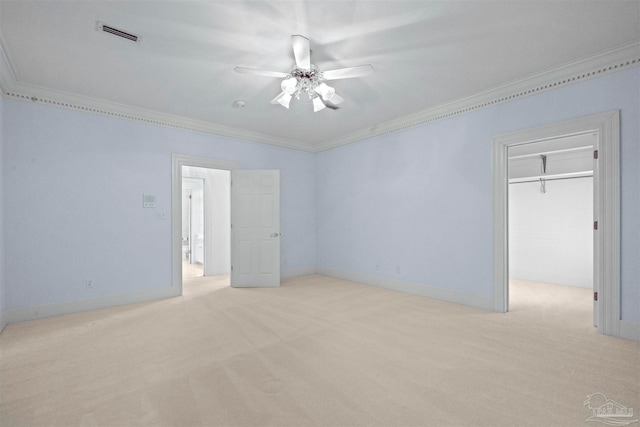 carpeted spare room with ornamental molding and ceiling fan