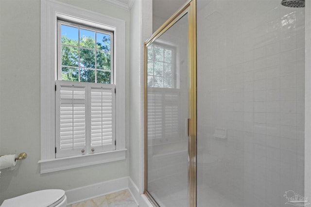 bathroom with toilet and a shower with door