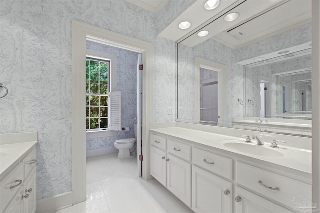 bathroom with ornamental molding, vanity, toilet, and tile patterned floors