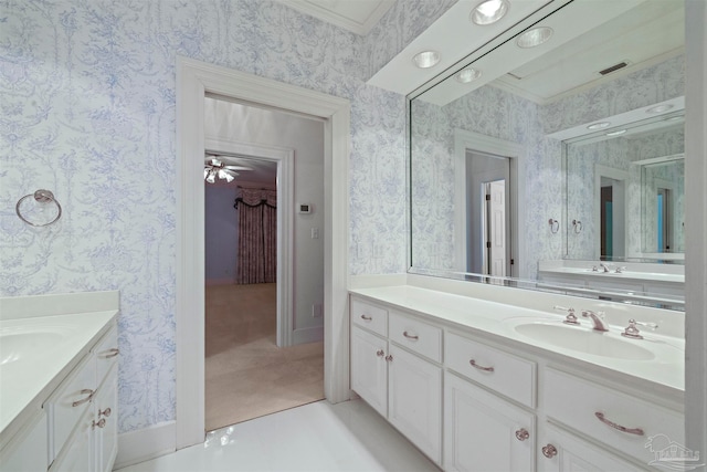 bathroom with ornamental molding, vanity, and ceiling fan