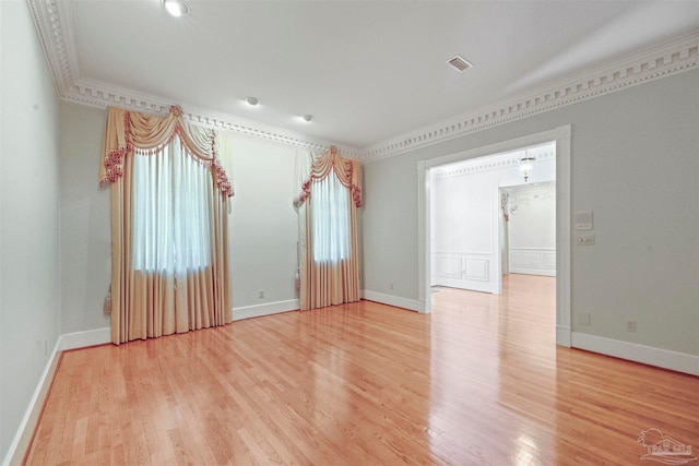 unfurnished room with light hardwood / wood-style floors and ornamental molding