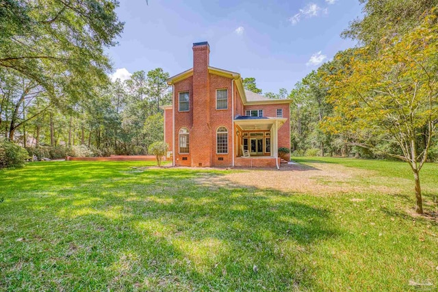 rear view of property with a yard