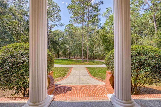 view of property's community featuring decorative columns