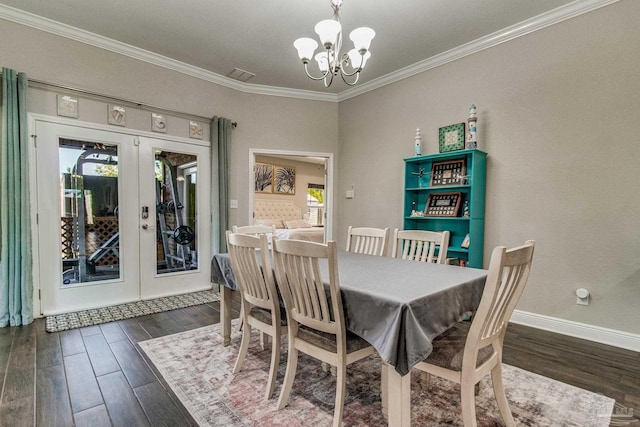 dining space featuring ornamental molding, dark wood-type flooring, a notable chandelier, and french doors