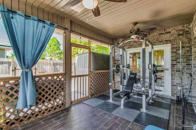 sunroom / solarium with wood ceiling and ceiling fan