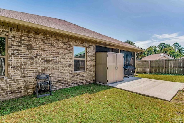 back of property featuring a patio and a lawn