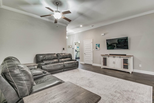 living room with ornamental molding, dark hardwood / wood-style floors, and ceiling fan