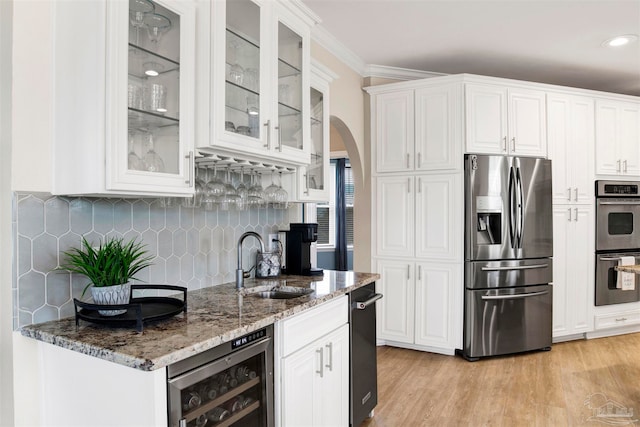 kitchen with white cabinetry, light hardwood / wood-style flooring, wine cooler, stainless steel appliances, and sink