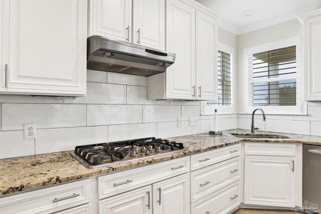 kitchen featuring white cabinets, light stone counters, stainless steel appliances, light hardwood / wood-style floors, and a kitchen island