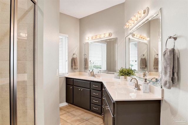 bathroom with tile patterned floors, a shower with door, and vanity