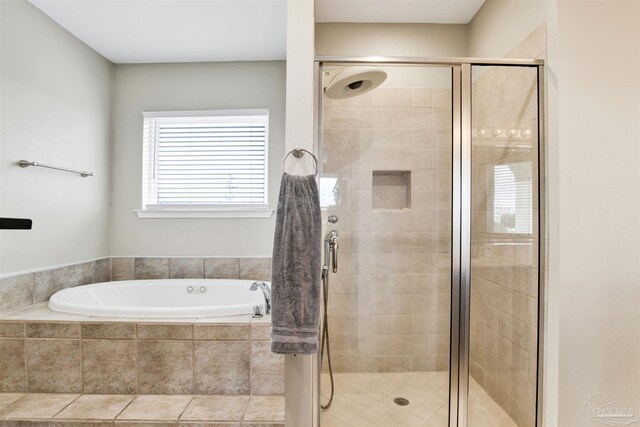 bathroom featuring tile patterned flooring, independent shower and bath, and vanity