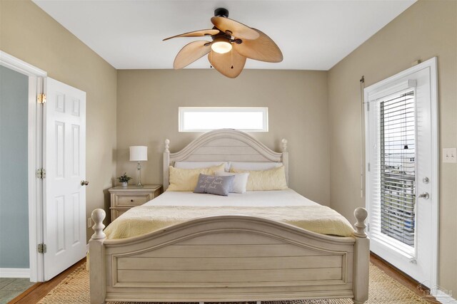 bedroom featuring light hardwood / wood-style floors, ceiling fan, and access to outside