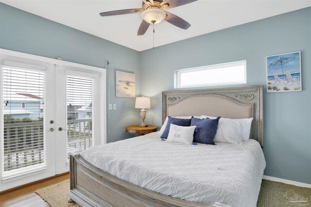 bedroom featuring multiple windows, ceiling fan, access to outside, and light hardwood / wood-style flooring