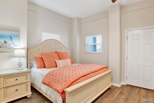 bedroom with dark hardwood / wood-style flooring