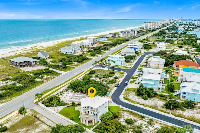 drone / aerial view featuring a beach view and a water view