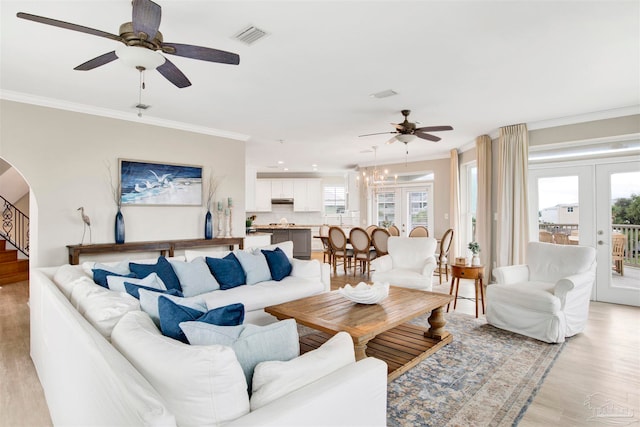 living room featuring ornamental molding, french doors, light hardwood / wood-style flooring, and ceiling fan