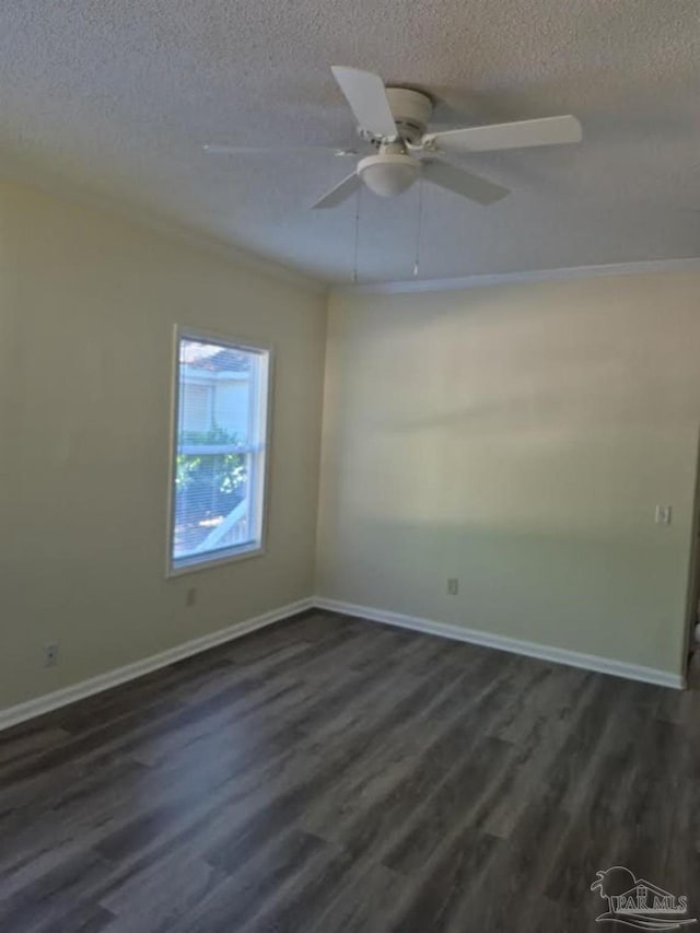 2008 Augusta Ave, Pensacola, FL 32507 - spare room featuring a textured ceiling, dark wood-style floors, and baseboards