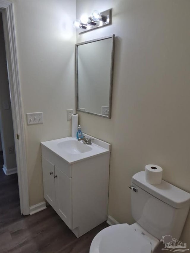 2008 Augusta Ave, Pensacola, FL 32507 - half bath with toilet, vanity, wood finished floors, and baseboards