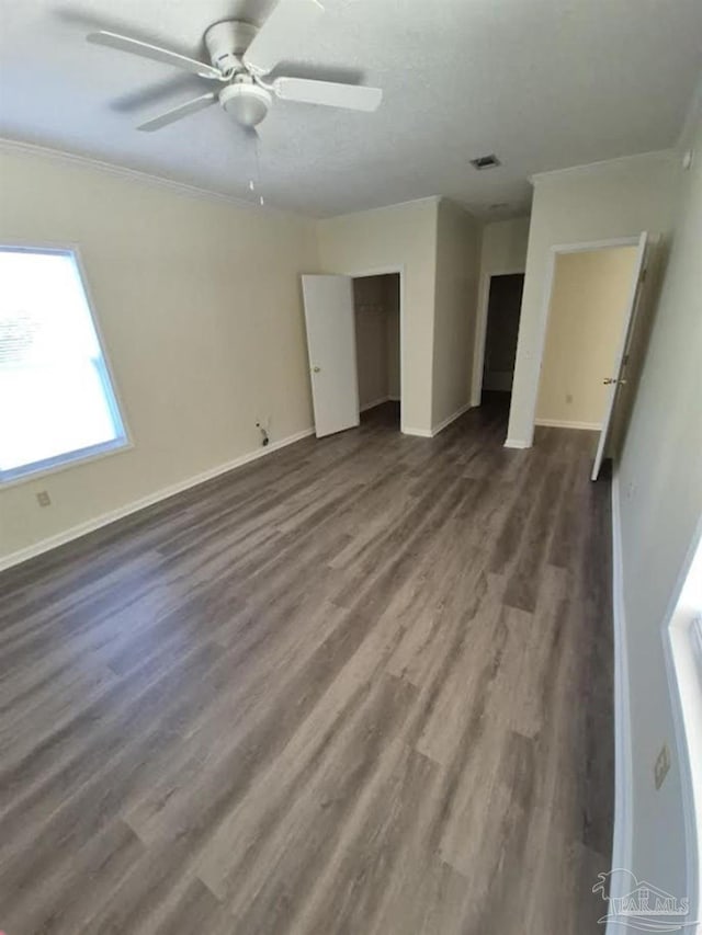 2008 Augusta Ave, Pensacola, FL 32507 - unfurnished bedroom featuring dark wood-style floors, baseboards, ornamental molding, ceiling fan, and a closet