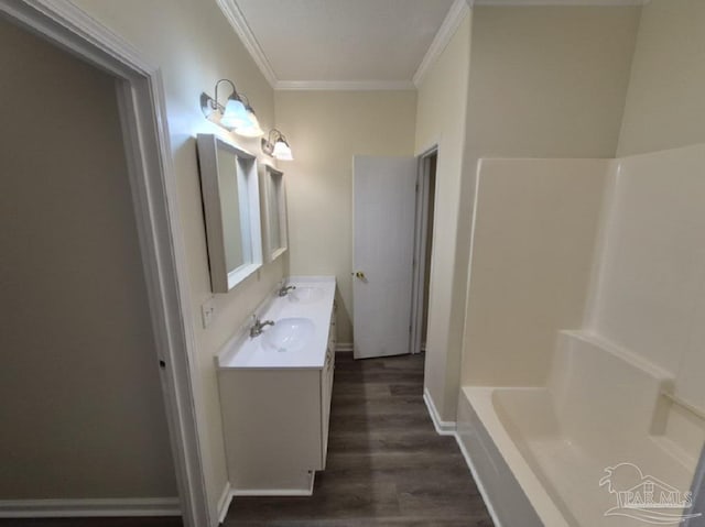 2008 Augusta Ave, Pensacola, FL 32507 - bathroom with crown molding, wood finished floors, a bath, baseboards, and double vanity