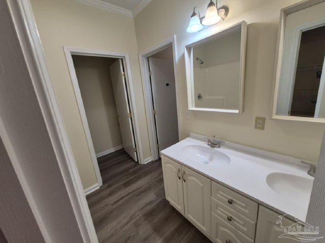 2008 Augusta Ave, Pensacola, FL 32507 - full bathroom featuring crown molding, wood finished floors, double vanity, baseboards, and a shower