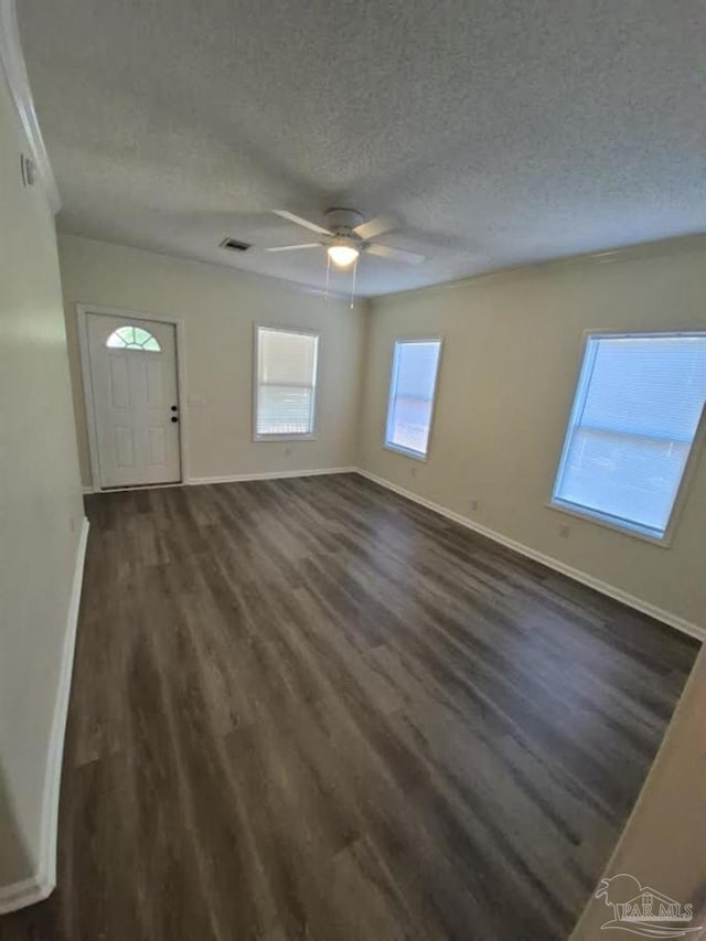 2008 Augusta Ave, Pensacola, FL 32507 - foyer featuring baseboards, a textured ceiling, dark wood-style flooring, and ceiling fan