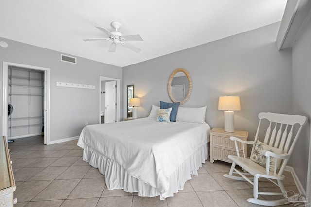 bedroom featuring visible vents, a closet, light tile patterned floors, baseboards, and ceiling fan