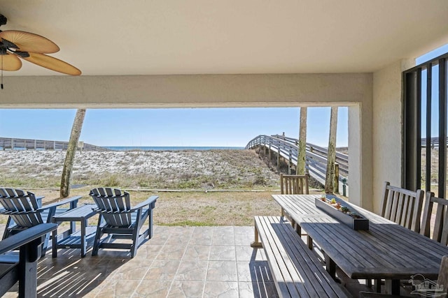 view of patio with outdoor dining space and ceiling fan