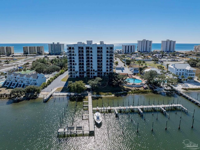 birds eye view of property with a view of city and a water view