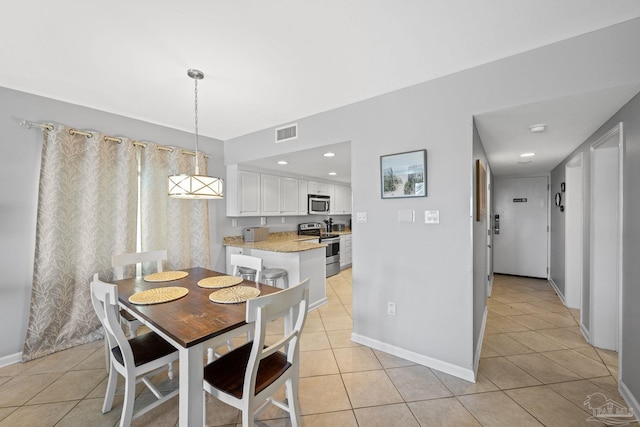 dining area featuring recessed lighting, light tile patterned floors, visible vents, and baseboards