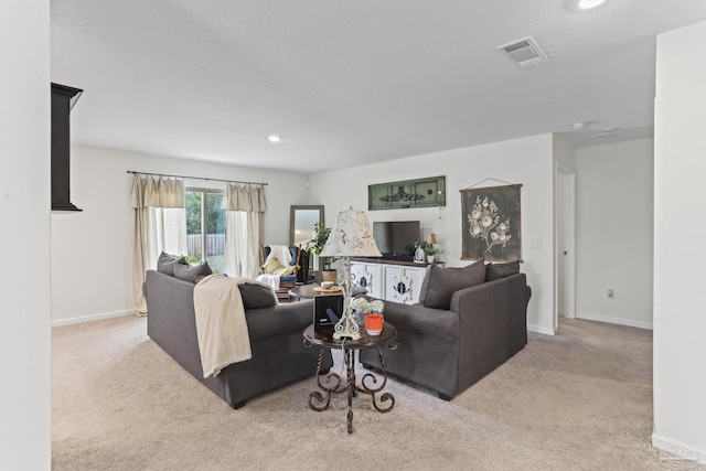 living room featuring baseboards, visible vents, and carpet flooring